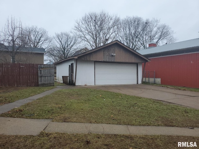 view of side of property with a yard, a garage, and an outdoor structure