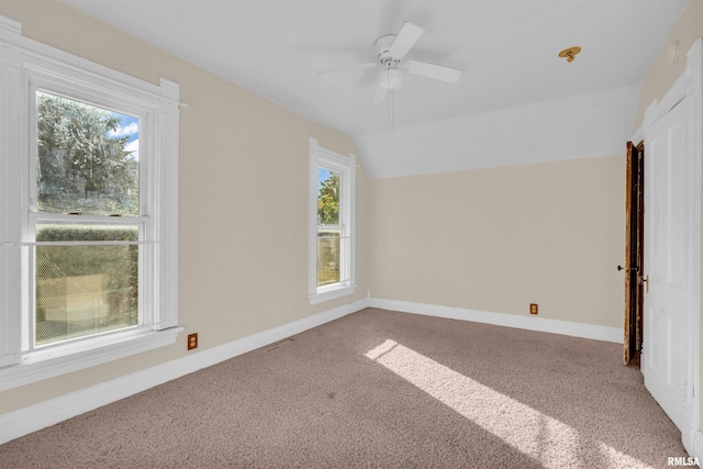 spare room with carpet flooring, ceiling fan, and vaulted ceiling