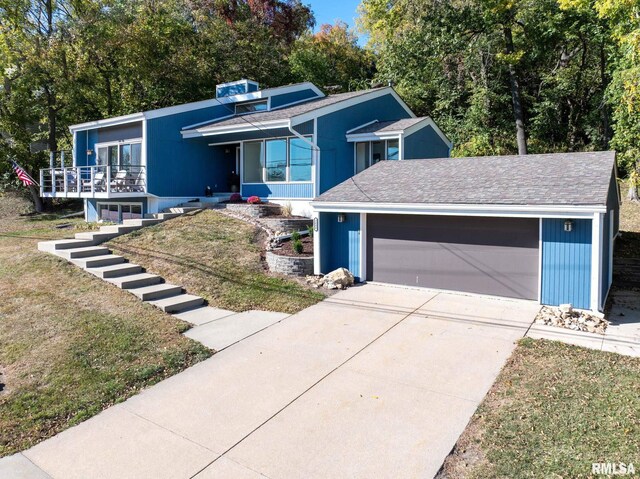 view of front of property with a garage and a front lawn