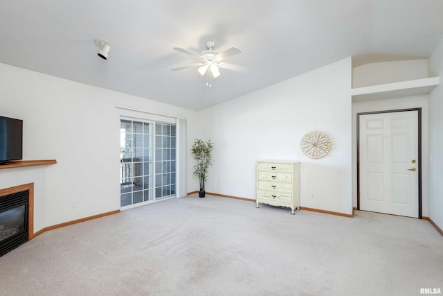 unfurnished living room with carpet flooring, ceiling fan, and vaulted ceiling