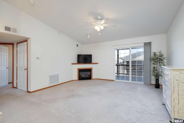 unfurnished living room with ceiling fan, light colored carpet, and lofted ceiling