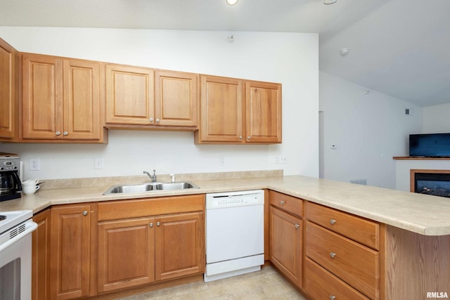 kitchen with white appliances, kitchen peninsula, sink, and vaulted ceiling