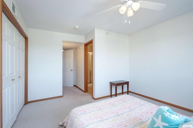 bedroom featuring ceiling fan, light colored carpet, and a closet