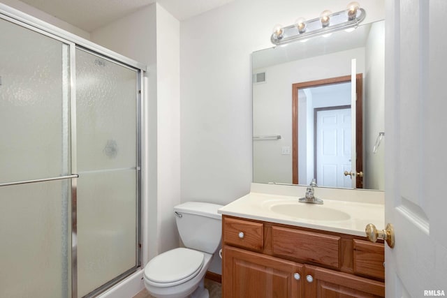 bathroom featuring walk in shower, vanity, and toilet