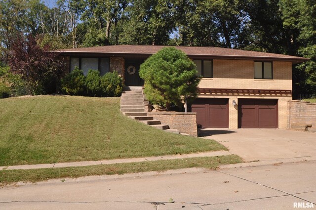 view of front of home with a garage and a front lawn