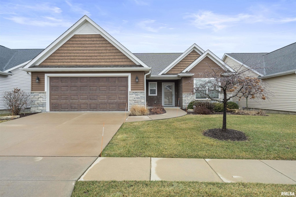 view of front of property with a front yard and a garage