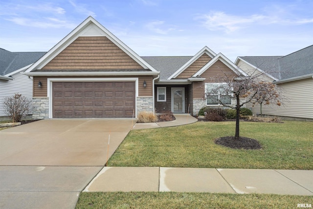 view of front of property with a front yard and a garage