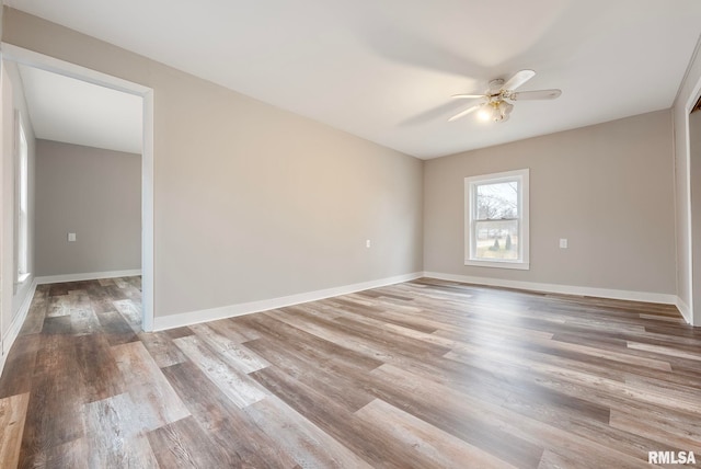 empty room with ceiling fan and light wood-type flooring