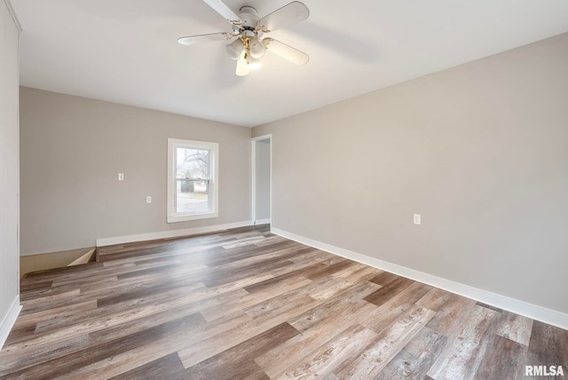 empty room featuring hardwood / wood-style flooring and ceiling fan