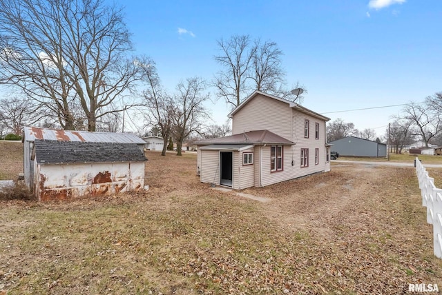 view of property exterior featuring a yard and an outbuilding