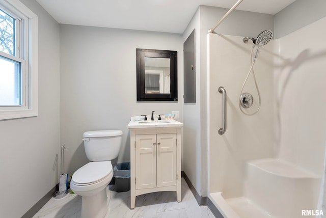 bathroom featuring vanity, toilet, and a shower