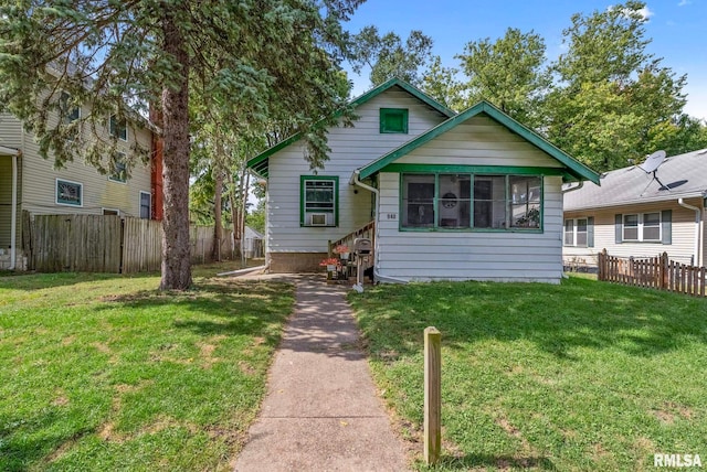 bungalow-style home with a front yard