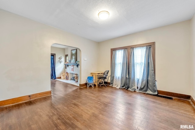 spare room featuring a textured ceiling and hardwood / wood-style flooring