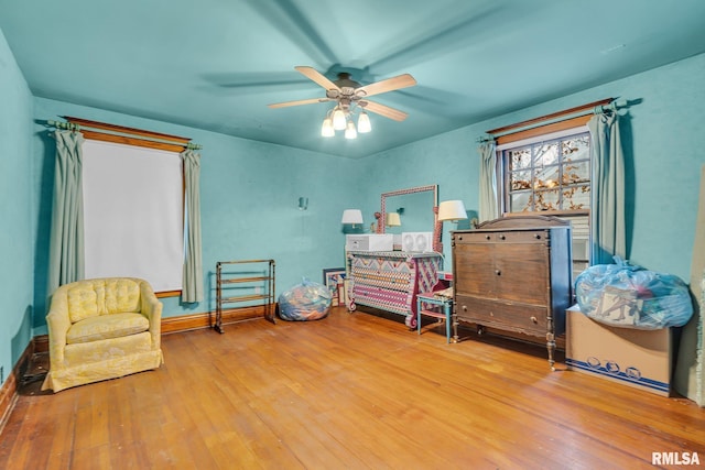 sitting room featuring hardwood / wood-style flooring and ceiling fan