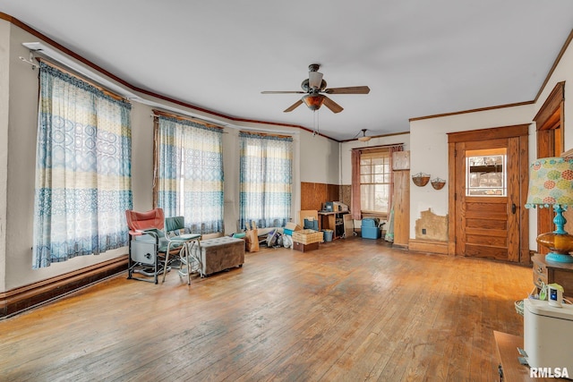 miscellaneous room featuring ceiling fan, crown molding, a wealth of natural light, and light hardwood / wood-style flooring