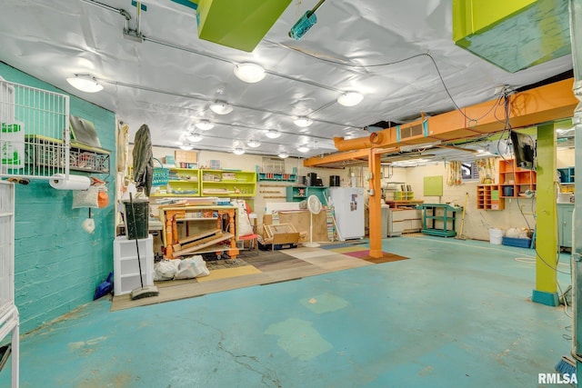 basement featuring a workshop area and refrigerator