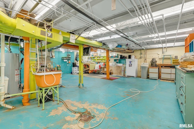 basement with a workshop area and water heater