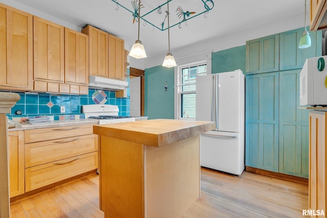 kitchen with a center island, wood counters, pendant lighting, white appliances, and decorative backsplash