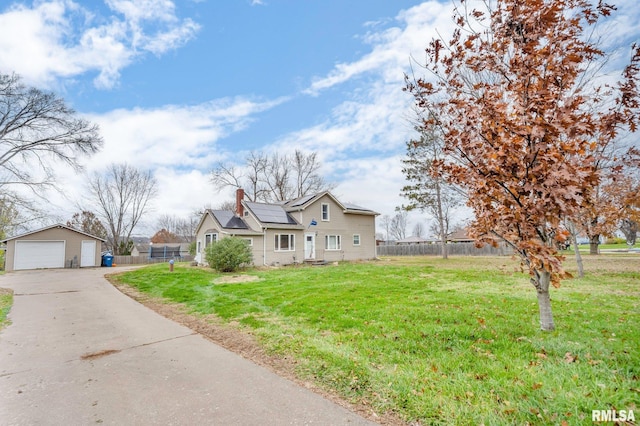 view of front of house with an outbuilding, a front lawn, and solar panels