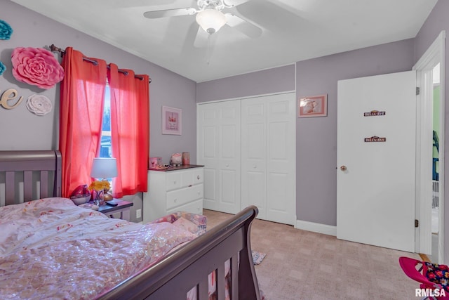 carpeted bedroom featuring ceiling fan and a closet