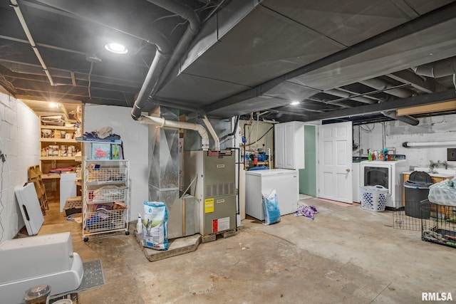 basement with heating unit, separate washer and dryer, and refrigerator