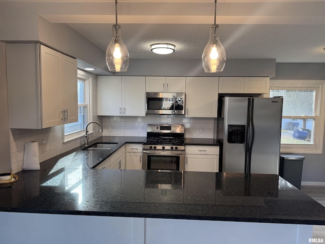 kitchen with sink, white cabinetry, and stainless steel appliances