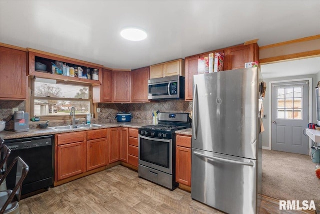 kitchen featuring backsplash, sink, stainless steel appliances, and light hardwood / wood-style flooring