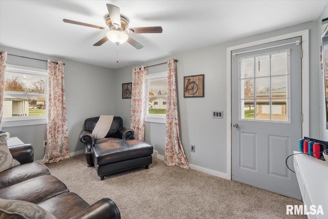 sitting room with ceiling fan and light carpet