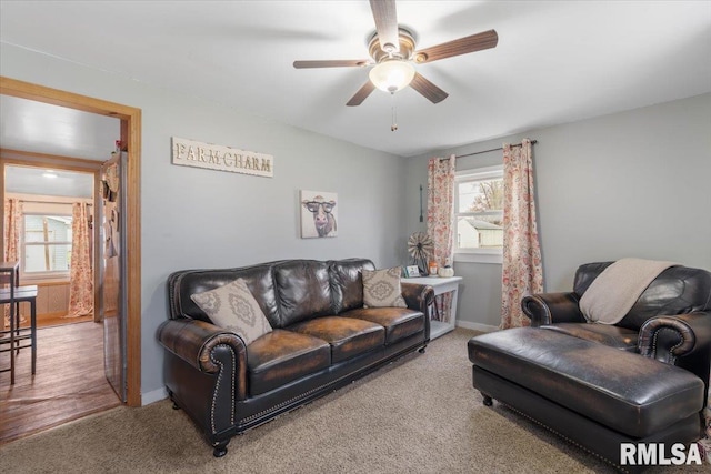 living room with ceiling fan and carpet floors