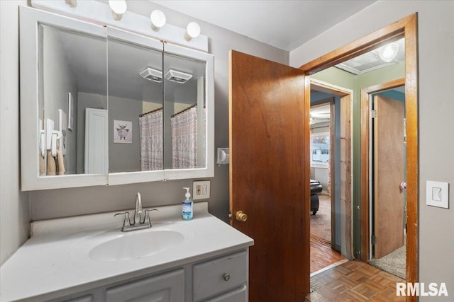 bathroom featuring vanity and parquet flooring