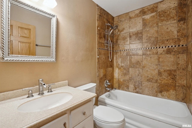 full bathroom with toilet, vanity, and tiled shower / bath