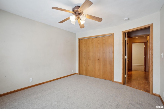 unfurnished bedroom with light colored carpet, a closet, and ceiling fan