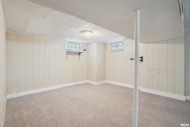 basement with carpet and a textured ceiling