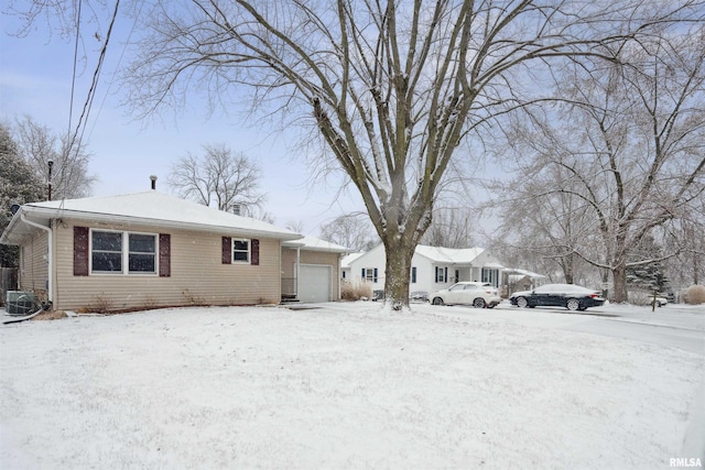 view of front facade with a garage and central AC unit