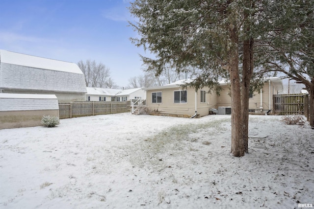 view of snow covered rear of property