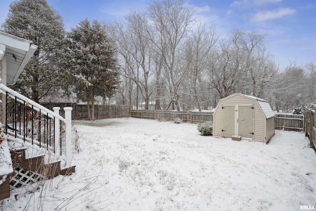 snowy yard with a shed