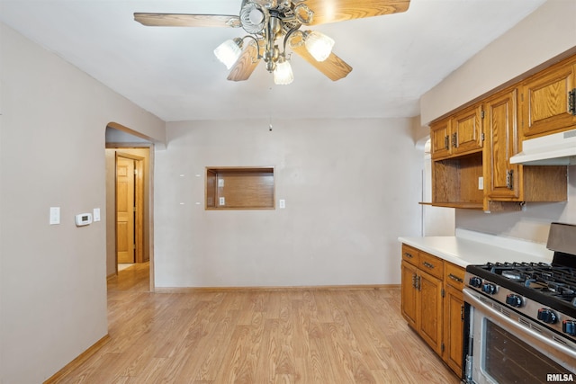 kitchen featuring ceiling fan, light hardwood / wood-style flooring, and stainless steel range with gas stovetop