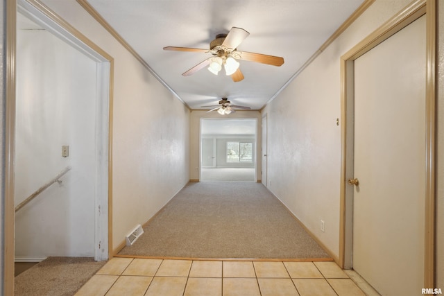 hallway featuring light carpet and ornamental molding