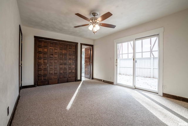 unfurnished bedroom featuring carpet, access to exterior, and ceiling fan