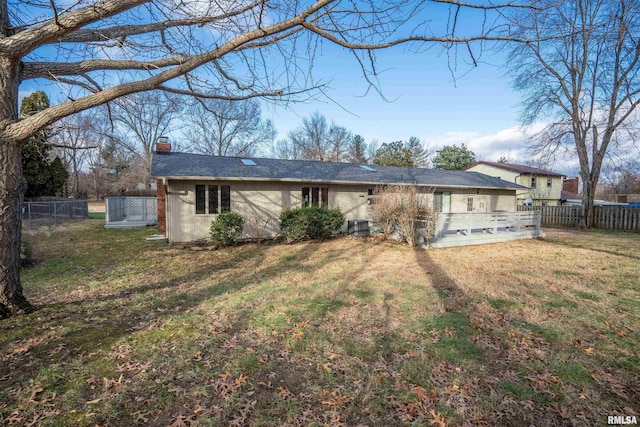 back of house featuring a yard