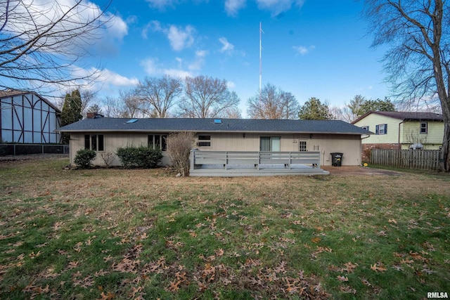 back of house with a yard, a deck, and a patio area