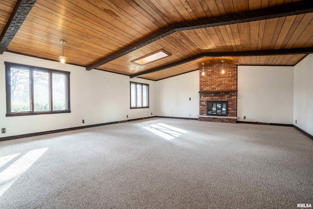 unfurnished living room featuring lofted ceiling with skylight, a fireplace, carpet floors, and wooden ceiling