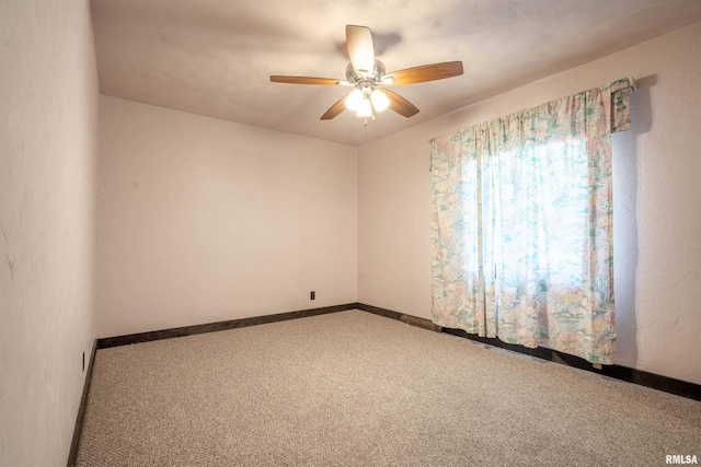 spare room featuring ceiling fan and carpet floors