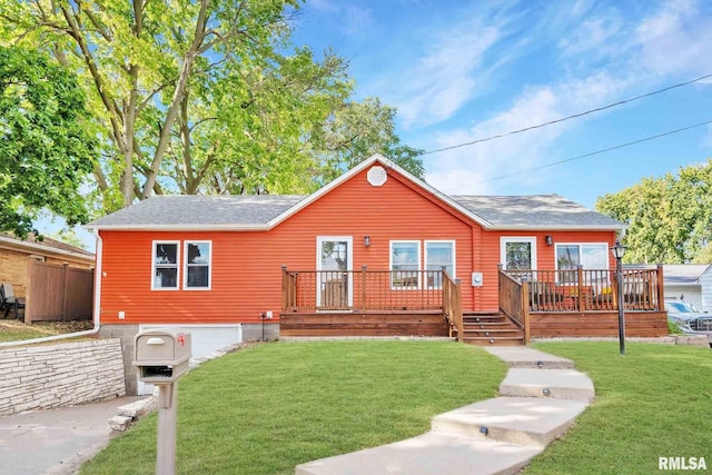 view of front facade with a deck and a front lawn