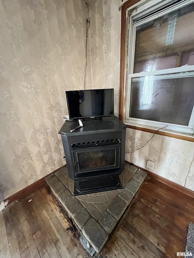 room details featuring wood-type flooring and a wood stove