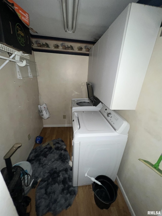 clothes washing area with hardwood / wood-style flooring and washer and clothes dryer