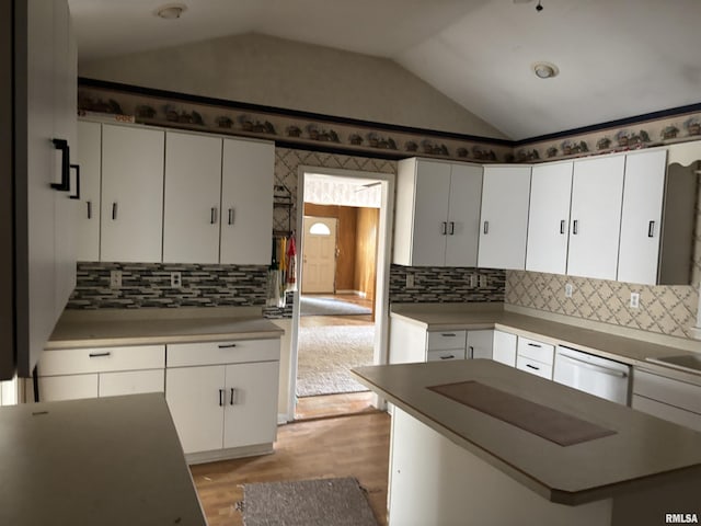 560 4th Ave S, Clinton, IA 52732 - kitchen featuring dishwasher, lofted ceiling, white cabinetry, light wood finished floors, and tasteful backsplash
