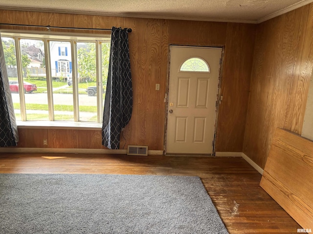560 4th Ave S, Clinton, IA 52732 - foyer featuring wood-type flooring, wooden walls, baseboards, and ornamental molding