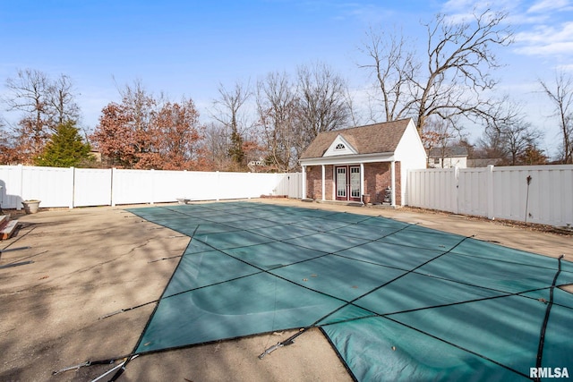 view of swimming pool with a patio area and an outbuilding