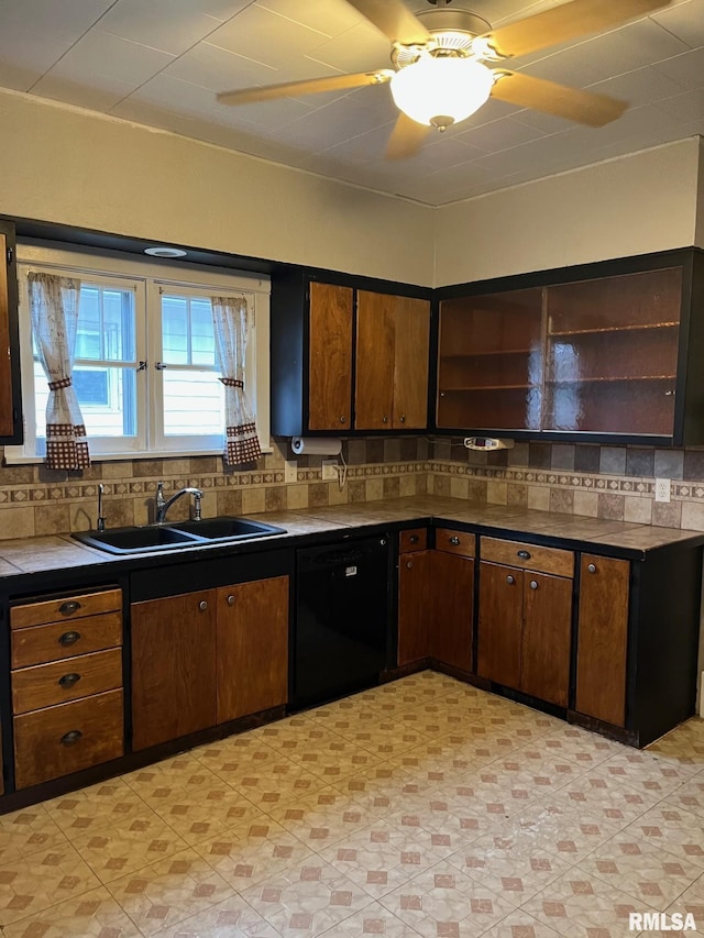 kitchen featuring decorative backsplash, dark brown cabinetry, ceiling fan, sink, and dishwasher